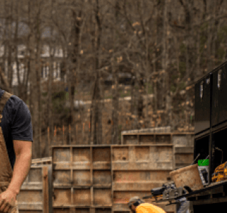 Two men walking on a new home construction site