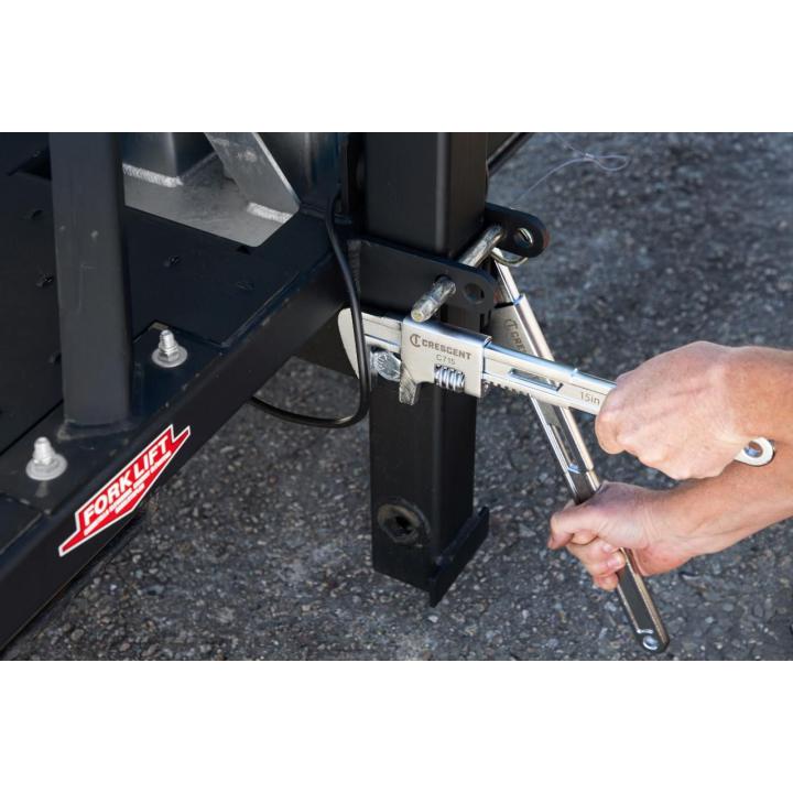 Image of the GEARWRENCH 15" Automotive Wrench being used by a person tightening a nut on a fork lift