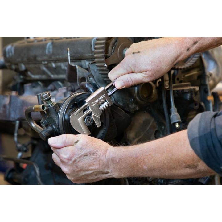 This images shows a person using the GEARWRENCH 9" Automotive Wrench being used on a nut on a engine block